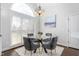 Dining room featuring a glass table, soft chairs, large bright window and modern chandelier at 4270 Aviemore Run, Burlington, NC 27215