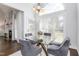 Dining room featuring a glass table, soft chairs, large bright window and modern chandelier at 4270 Aviemore Run, Burlington, NC 27215