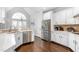 Bright kitchen featuring white cabinets, stainless steel appliances, hardwood floors, and ample counter space at 4270 Aviemore Run, Burlington, NC 27215