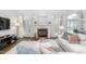 Well-lit living area featuring a fireplace and a seamless transition to the dining space at 4270 Aviemore Run, Burlington, NC 27215