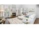 Spacious living room featuring a fireplace, large windows, hardwood floors, and elegant white furniture at 4270 Aviemore Run, Burlington, NC 27215