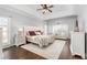 Large bedroom with ceiling fan, sitting area, dresser, bedside tables and hardwood floors at 4270 Aviemore Run, Burlington, NC 27215