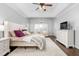 Spacious bedroom with ceiling fan, sitting area, dresser, bedside tables and hardwood floors at 4270 Aviemore Run, Burlington, NC 27215