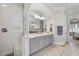 Elegant bathroom featuring a spacious shower with bench, double vanity, and linen closet at 432 Nickel Creek Cir, Cary, NC 27519