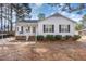 Charming single-story home featuring white siding, black shutters, and a cozy front porch at 435 Fowlkes St, Wendell, NC 27591