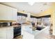 Sunlit kitchen featuring white cabinetry, center island, and modern appliances at 475 Beechmast, Pittsboro, NC 27312