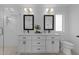 Modern bathroom with dual vanity, stylish mirrors, and a glass-enclosed shower, creating a spa-like experience at 5 Bart St, Raleigh, NC 27610