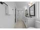 Bright bathroom featuring a double sink vanity, modern lighting, and a sleek glass-enclosed shower at 5 Bart St, Raleigh, NC 27610