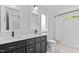Bathroom with a double sink vanity with modern lighting, a separate toilet room, and a tub with shower at 5 Bart St, Raleigh, NC 27610
