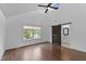 Spacious bedroom with ceiling fan and barn door leading to ensuite bathroom, offering privacy and style at 5 Bart St, Raleigh, NC 27610