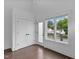 Bright bedroom with hardwood floors, double door closet, and large windows with neighborhood views at 5 Bart St, Raleigh, NC 27610
