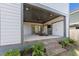 Spacious covered patio with a fireplace and tv that connects seamlessly to the backyard at 5 Bart St, Raleigh, NC 27610