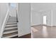Open-concept entryway with dark wood floors and white trim, leading to the staircase and main living area at 5 Bart St, Raleigh, NC 27610