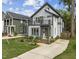 Modern two-story home with gray siding, black trim, a second story balcony, and a beautifully landscaped front yard at 5 Bart St, Raleigh, NC 27610