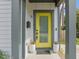 Welcoming front door with a bright yellow color and two potted plants on the porch at 5 Bart St, Raleigh, NC 27610