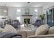 Bright living room featuring a fireplace, two chairs, and ample natural light at 5 Bart St, Raleigh, NC 27610