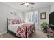 Cozy bedroom with plantation shutters, ceiling fan, and a comfortable bed with patterned bedding at 516 Ivy Arbor Way, Holly Springs, NC 27540