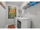 Well-equipped laundry room with modern washer and dryer, plus convenient shelving for storage at 516 Ivy Arbor Way, Holly Springs, NC 27540