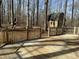 Wooden deck overlooking backyard with tree shed, bordered by trees and slide set at 5405 Friendship Patterson Mill Rd, Burlington, NC 27215