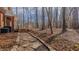 Stone pathway and backyard featuring a wood deck and trees at 5405 Friendship Patterson Mill Rd, Burlington, NC 27215