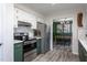 Modern kitchen with stainless steel appliances and stylish cabinets adjacent to the dining room at 5417 Walton Hill Rd, Knightdale, NC 27545