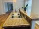 Kitchen area featuring stainless steel sink, speckled countertops, and views to other rooms at 5740 Lemon Springs Rd, Sanford, NC 27332