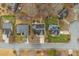 Birds eye view of three homes in a residential neighborhood, featuring lawns, driveways, and street access at 610 Brownstone Rd, Gibsonville, NC 27249