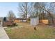 Landscaped backyard with a storage shed at 610 Brownstone Rd, Gibsonville, NC 27249