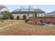 Backyard view of house with solar panels, patio, brick wall and landscaping at 610 Brownstone Rd, Gibsonville, NC 27249