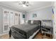 Bedroom features plantation shutters, sleek black furniture and ample natural light at 610 Brownstone Rd, Gibsonville, NC 27249
