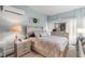 A serene bedroom featuring a decorative headboard, a modern air conditioning unit and soft natural light at 610 Brownstone Rd, Gibsonville, NC 27249