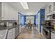 Charming eat-in kitchen with blue walls, white cabinets, and modern stainless steel appliances at 610 Brownstone Rd, Gibsonville, NC 27249