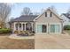 Charming home featuring a blend of brick and siding, a welcoming front porch, and well-maintained landscaping at 610 Brownstone Rd, Gibsonville, NC 27249