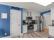 Well-equipped kitchen with stainless steel appliances, granite counters, white cabinets and hardwood floors at 610 Brownstone Rd, Gibsonville, NC 27249