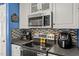 Modern stainless steel range, microwave and decorative backsplash in this well-appointed kitchen space at 610 Brownstone Rd, Gibsonville, NC 27249