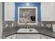 Close-up of kitchen sink, decorative backsplash, and window with ironwork detail at 610 Brownstone Rd, Gibsonville, NC 27249