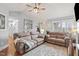 Open-concept living room featuring hardwood floors, a fireplace, and comfortable seating arrangements at 610 Brownstone Rd, Gibsonville, NC 27249