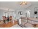 Bright living room adjacent to a dining area, featuring hardwood floors and comfortable seating at 610 Brownstone Rd, Gibsonville, NC 27249