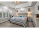 Spacious main bedroom with patterned bedding, a ceiling fan and large windows at 610 Brownstone Rd, Gibsonville, NC 27249