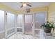 Sun room featuring many windows and tile flooring, perfect for relaxation and enjoying natural light at 610 Brownstone Rd, Gibsonville, NC 27249