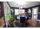 Bright dining room with blue walls, lots of windows, and plant accents at 6217 Dawn Dr, Hurdle Mills, NC 27541