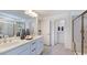 Bright bathroom featuring a double vanity, modern fixtures, and a glass shower at 627 Contento Ct, Sanford, NC 27330
