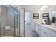 Bathroom showcasing glass enclosed shower, double vanity with elegant fixtures, and a view to bedroom at 627 Contento Ct, Sanford, NC 27330