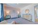 Bright Bedroom featuring crib, changing table, and patterned accent wall at 627 Contento Ct, Sanford, NC 27330