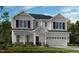 New two-story home showcasing white siding, black shutters, an attached two-car garage, and a manicured front lawn at 627 Contento Ct, Sanford, NC 27330
