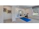 Clean fitness room with exercise bike, mirrors, and plenty of natural light creating an inviting workout space at 627 Contento Ct, Sanford, NC 27330