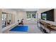 Dedicated fitness room equipped with exercise equipment, a large mirror, and natural light from the window at 627 Contento Ct, Sanford, NC 27330