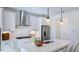 Modern kitchen with white cabinets, stainless steel appliances, and a stylish backsplash at 627 Contento Ct, Sanford, NC 27330