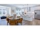 Well-lit kitchen showcasing stainless steel appliances, white cabinets, and a stylish island with bar seating at 627 Contento Ct, Sanford, NC 27330