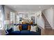 Bright living room with a stylish blue sofa, an open floor plan, and modern decor at 627 Contento Ct, Sanford, NC 27330